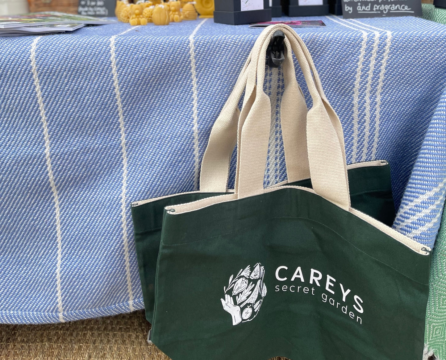 Carey’s canvas tote bag, featuring a simple, stylish design with the Carey’s logo, perfect for carrying essentials while supporting sustainable, eco-conscious brands